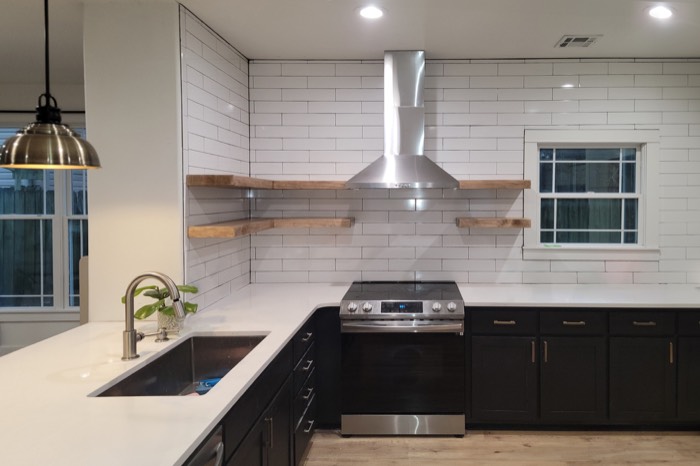 Remodeled kitchen with subway tile and floating shelves